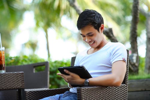 Man in White Shirt Using Tablet Computer